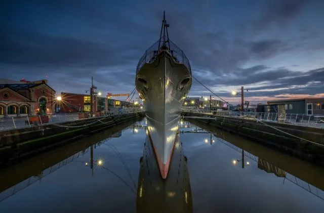 HMS Caroline at dusk. credit Six Mile images